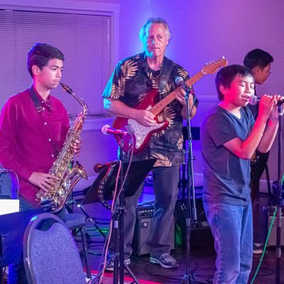 saxophone student and singer performing with teacher