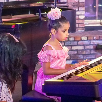 little girl performing piano rockside concert